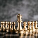 Gold Chess on chess board game for business metaphor leadership